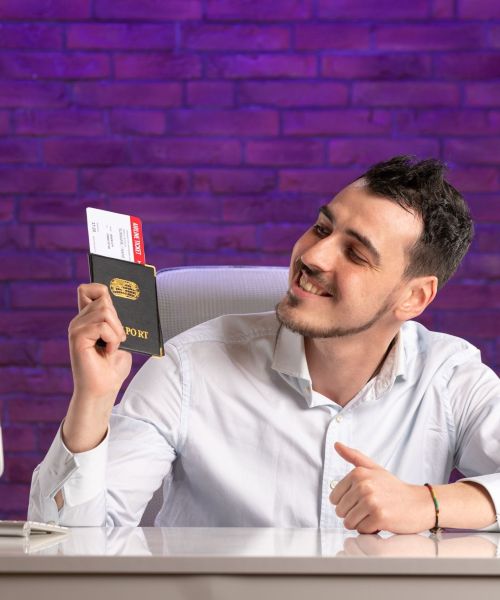 front-view-office-worker-sitting-his-working-place-holding-tickets-passport front-view-office-worker-sitting-his-working-place-holding-tickets-passport