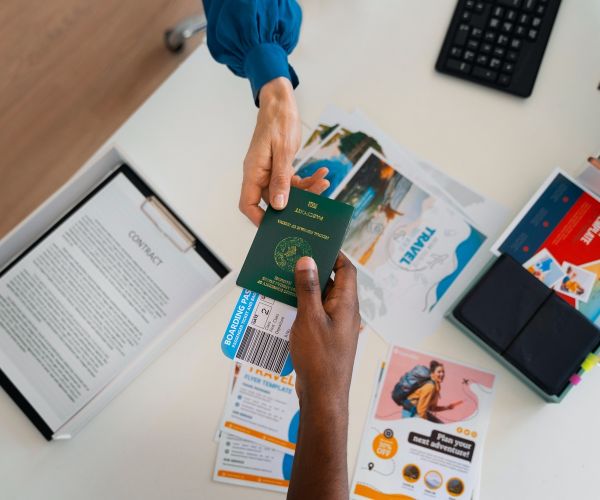 top-view-hands-holding-travel-documents